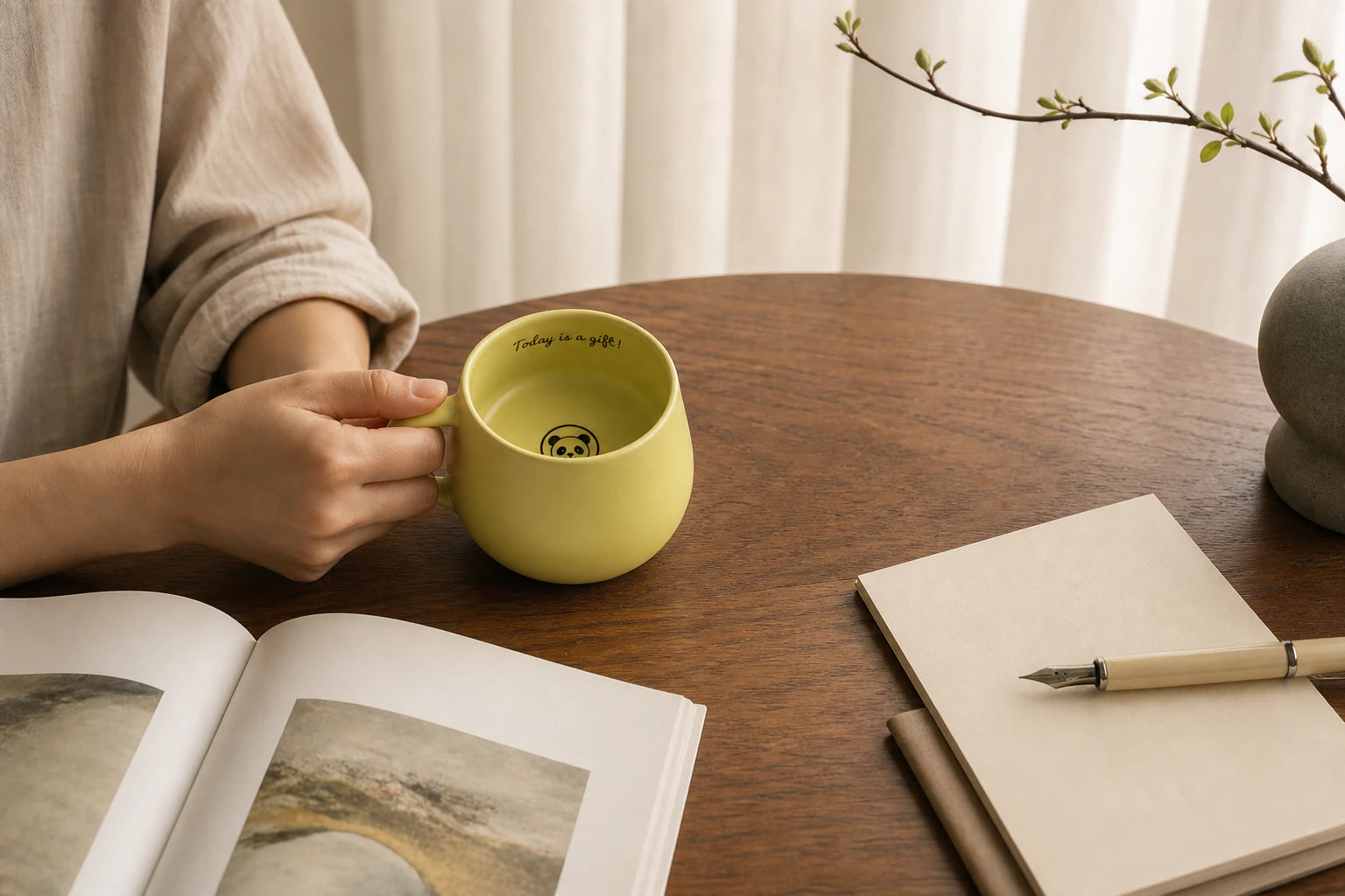 An Urboria Orivon mug beside a book during an afternoon break