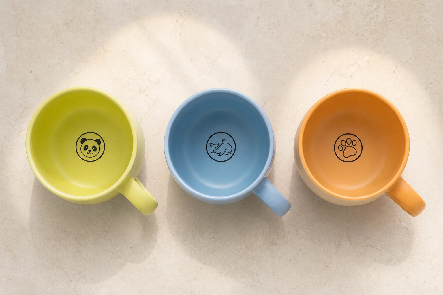 Panda, whale, and paw illustrations inside three Urboria Orivon mugs